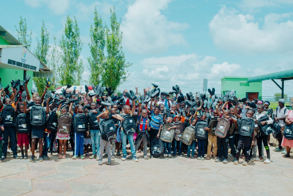 Children celebrating with new school shoes at the Back to School Drive