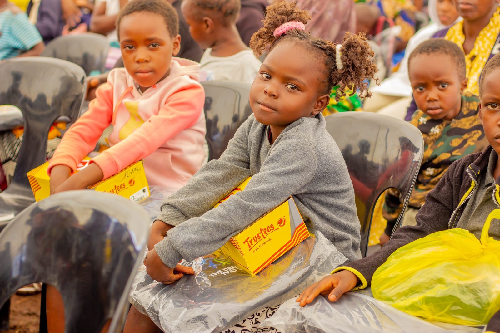 Volunteers distributing shoes to students